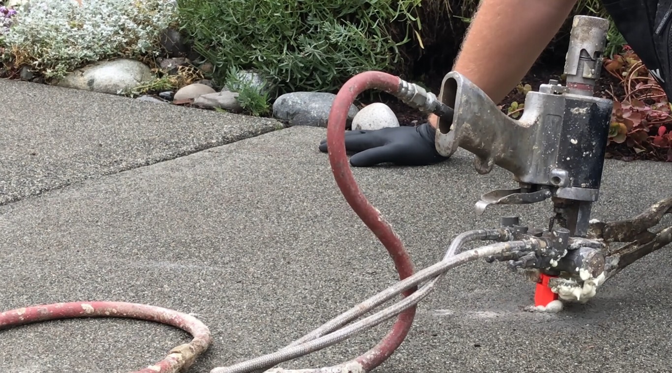 Concrete repair and crack filling on a residential driveway